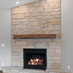 673 Black Earth Fireplace. Raised Limeston Hearth Extension. Downtown King Street Luxury Vinyl Plank Floors. 70% Fond du Lac Buff With 30% Long Island Tumbled Natural Thin Stone Surround. Reclaimed Timber Epoxy Mantel.