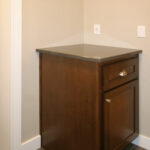 1502 Maple Hills Back Entry + Stained Maple Flat Panel Drop Zone Cabinet with Quartz Countertops. Staggered Joint 12x24 Tiled Flooring.