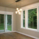 1502 Maple Hills Dinette. Window with Painted Trim, Extended Sill, and Built-Up 3-Piece Head Trim with Crown Molding. Luxury Vinyl Plank Floors.