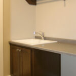 1502 Maple Hills Laundry Room. Ceramic Tile Staggered Joint on 1/3. Folding Counter Open Below.