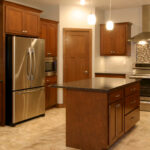1800 Sonata Kitchen. Custom Stained Maple Flat Panel Cabinets with Granite Countertops, Tiled Backsplash, Under-Cabinet Lighting, and Ceramic Tile Floors.