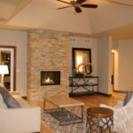 3424 Schubert Living Room. 36" Deep Beveled Tray Ceiling. Stacked Stone Fireplace Surround. Natural Maple Hardwood Floors.