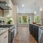 3492 Yorkshire Kitchen. Painted Perimeter Cabinets with Espresso Stained Maple Island. Granite Countertops. Tiled Backsplash. Luxury Vinyl Plank Floors.