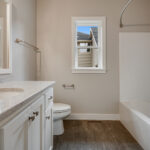 3492 Yorkshire Main Bathroom. Stone Countertops. Vinyl Tile Flors. Painted Cabinets. Wood Framed Mirror.