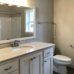 3492 Yorkshire Main Bathroom Vanity. Stone Countertops. Painted Cabinets. Wood Framed Mirror.