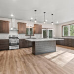 6067 Governors Woods Kitchen. Shiplap Island Base. Stained Maple Flat Panel Custom CAbinets. Luxury Vinyl Plank Floors. Subway Tile Backsplash.