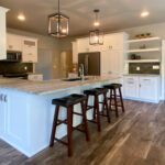 7714 Saint Andrews Kitchen. Peninsula Snack Counter. Floating Shelves. Tiled Backsplash. White painted flat panel custom cabinets. Hutch style upper cabinets.