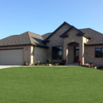 Schubert 3424 Exterior. All Brick. Dark Bronze Windows Soffit Fascia. Arched Entry.