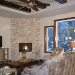 1726 Symphony Heights Great Room + Stacked Stone Fireplace + Tray Ceiling with Ceiling Beams