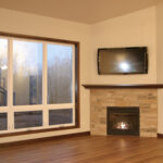 5012 Potters Crossing Great Room + Fireplace. Stone Fireplace to Mantel Height. Luxury Vinyl Plank Floors. TV Above Fireplace.