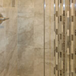 5012 Potters Crossing Tiled Shower. Tiled Walls with Fiberglass Shower Base. Vertical Mosaic Glass Tile with Vertical 12x24 Tile. Shampoo Niche.
