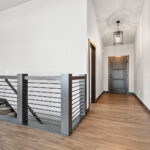 311 S Splake Foyer + Stairs. Custom Boxed Newels + Linear Tube Railing. Stained Fiberglass Entry Door.