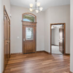 3597 E Hank Foyer. Arch-Top Transom. Stained Fiberglass Entry Door.