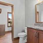 3320 Cottage Hill Powder Room. Granite countertops. Stained maple vanity cabinet. Wood framed mirror.