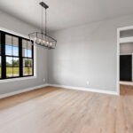 704 Royal St Pats Dining. Black Windows with White Painted Trim. Interior Transom. Luxury Vinyl Plank Floors.