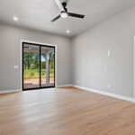 704 Royal St Pats Owners Bedroom. Black Patio Doors. Luxury Vinyl Plank Floors.
