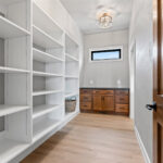 704 Royal St Pats Walk-In Pantry. Adjustable Shelving. Stained Maple Base Cabinet with Stone Countertop.