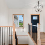 6170 Saint Patrick Foyer + Stairs. Square Edged Handrail. Plain Square Iron Metal Balusters. 4x4 Boxed Newel Posts.