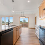 6170 Saint Patrick Kitchen. Maple Flat Panel Cabinets. White Quartz Countertops. White Tiled Backsplash. Slate Appliances.