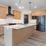 6170 Saint Patrick Kitchen. Maple Flat Panel Cabinets. White Quartz Countertops. White Tiled Backsplash. Slate Appliances.