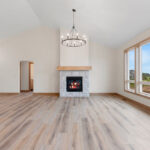 6170 Saint Patrick Living Room. Luxury Vinyl Plank Floors. Stone Fireplace Surround to Mantel Height. Cathedral Ceiling.