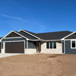 116 Cortland Exterior. Norandex Cedar Knolls Deep Water Siding. Norandex Home Accents Carbon Shake Siding. Dutch Quality Winter Point Weather Ledge Stone with SM200 Mortar. Brown Overhead Garage Doors & Front Door & Cedar Post (SW 3542 Charwood).