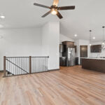 116 Cortland Living Room + Stairs. Vertical Black Iron Balusters with LJ Smith LJ-4000 Newel Posts. Luxury Vinyl Plank Floors.