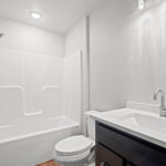 116 Cortland Main Bathroom. Quartz Countertops. Stained Maple Cabinets.