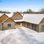 2966 Sugar Bush Exterior. LP SmartSide Diamond Kote "DuoBlend Bedrock" vertical board & batten siding with "DuoBlend Elkhorn" horizontal clapboard lap siding and "Coffee" trim. Eldorado "Mountain Ledge Silverton" stone.