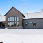 2966 Sugar Bush Exterior. LP SmartSide Diamond Kote "DuoBlend Bedrock" vertical board & batten siding with "DuoBlend Elkhorn" horizontal clapboard lap siding and "Coffee" trim. Eldorado "Mountain Ledge Silverton" stone.