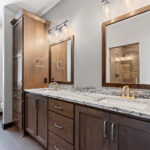 2966 Sugar Bush Owners Bathroom. Stained Knotty Alder Vanity Cabinet. Fantasy Blue Leathered Granite Countertops. Knight Tile "Bern Stone" Vinyl Tile Flooring. Corner Linen. Wood Framed Mirrors.