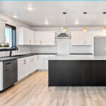525 E Greenfield Kitchen. White Painted Flat Panel Perimeter Cabinets with Stained Maple Island. Perimeter Laminate Countertops with Granite Island Countertop. White Subway Tile Kitchen Backsplash. Luxury Vinyl Plank Floors. Stainless Chimney Range Hood.
