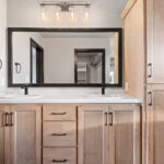 525 E Greenfield Owners Bathroom Vanity. Light Maple Stained Bathroom Vanity. Wood-Framed Mirror.