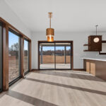 398 Red Tail Dining. Mid-Century Modern Revival. Tall Windows to Floor. Flush Slab-Front Stained Maple Cabinetry. Peninsula Snack Counter. 8 Foot Wide Patio Door. Luxury Vinyl Plank Floors. Floating Shelves.