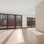 398 Red Tail Living Room. Mid-Century Modern Revival. Interior Brick Walls. Luxury Vinyl Plank Floors.