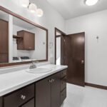 398 Red Tail Main Bathroom & Laundry. Mid-Century Modern Revival. Flush Slab-Front Stained Maple Cabinets. Linen with Countertop Above. Wood-Framed Mirror. Flush Veneer Maple Interior Doors.
