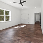 7730 Prestwick Bedroom #3 / Studio. White Painted Woodwork. 2-Panel Doors. Luxury Vinyl Plank Floors.