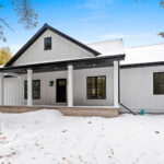 7730 Prestwick Exterior. DiamondKote LP Smartside White Vertical Board & Batten Siding. Black Windows. Black Soffit & Black Fascia.