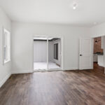 7730 Prestwick Owners Bedroom. White Painted Woodwork. Patio Doors in Bedroom. Luxury Vinyl Plank Floors. 2-Panel Doors.