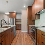 9185 Rasner Kitchen. Vertical Grain Black Walnut Slab Front Modern Cabinets. Alpine White Granite Countertops. Floating Shelves. Aquarelle 0 Vapor Tiled Backsplash. Farrington Crest Cigar Hickory Laminate Plank Flooring.