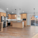 2202 Patty Ln Kitchen & Dining. Formica Cafe Azul 6319-43 countertops. Canyon Americas "Fall Branch Hickory" vinyl plank flooring. Cathedral ceiling. Stainless chimney range hood.