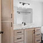2202 Patty Ln Owners Bathroom. Light stained maple vanity cabinet. Formica White Ice Granite 9476-58 countertops.